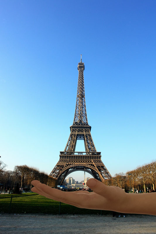 The Eiffel Tower in the hands of a child.